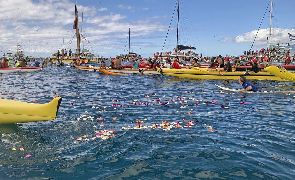 A paddle-out ceremony is held with surfers and boats to commemorate the first anniversary of the Lahaina wildfire, on Maui, Hawaii, August 8, 2024. Photo by Kyodo via Reuters