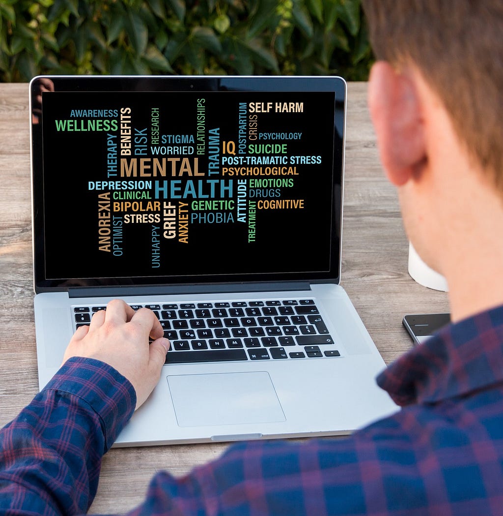A man on laptop screen with the cation mental health, social media