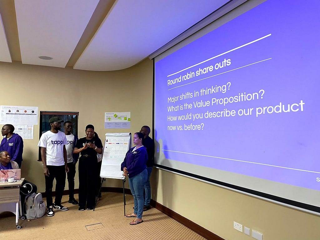 Ololade presenting on behalf of her team standing around her.