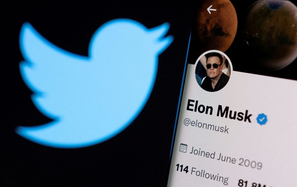 Elon Musk’s twitter account on a smartphone in front of the Twitter logo, April 15, 2022. Photo by Dado Ruvic/Reuters