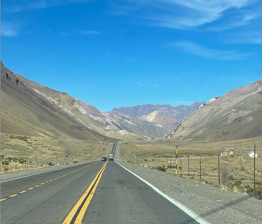 The Pan-American Highway between Chile and Argentina. It is a low populated place in the Andes, with only the road and the mountains.