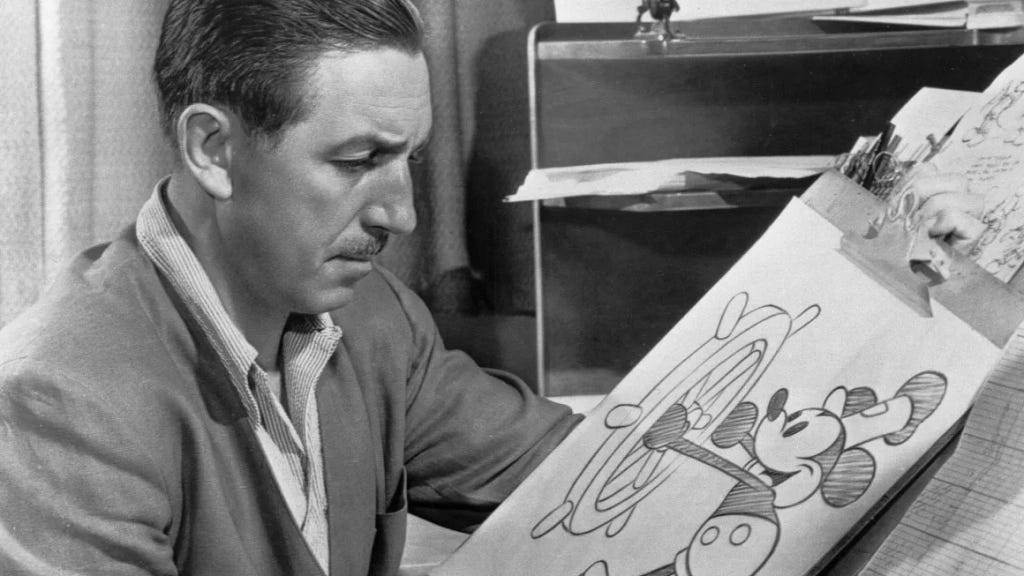 Walt Disney with a cartoon drawing of Mickey Mouse in Steamboat Willie