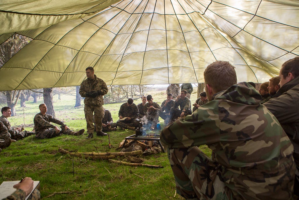 British Army staff Sergeant survival instructor teaches troops survival procedures