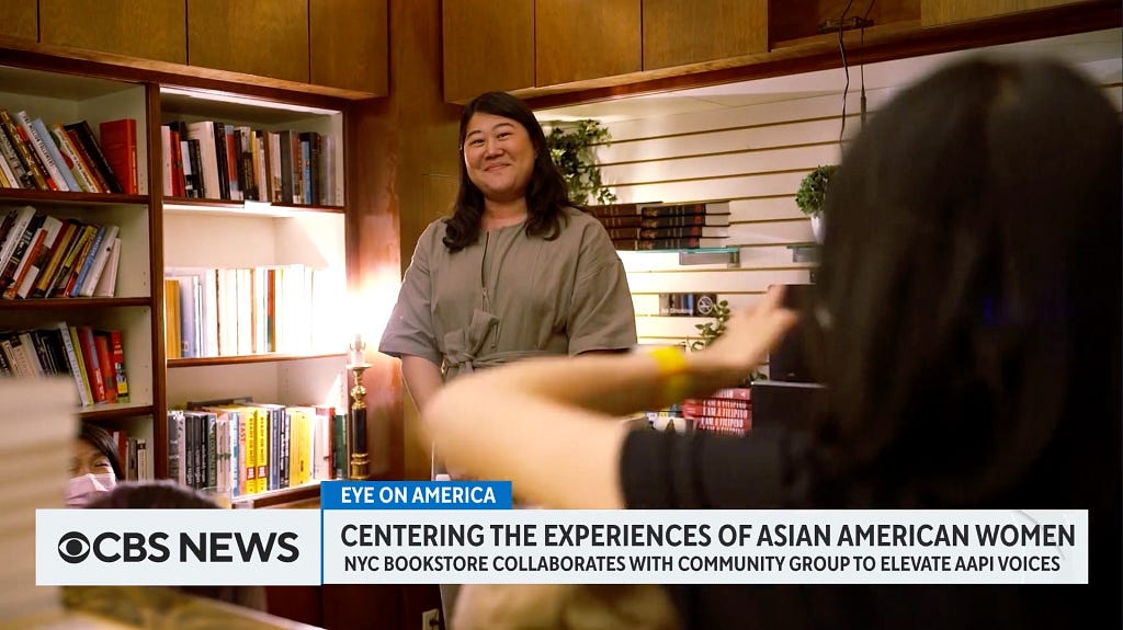 A screenshot of a CBS news clip where Nicole stands in a bookstore