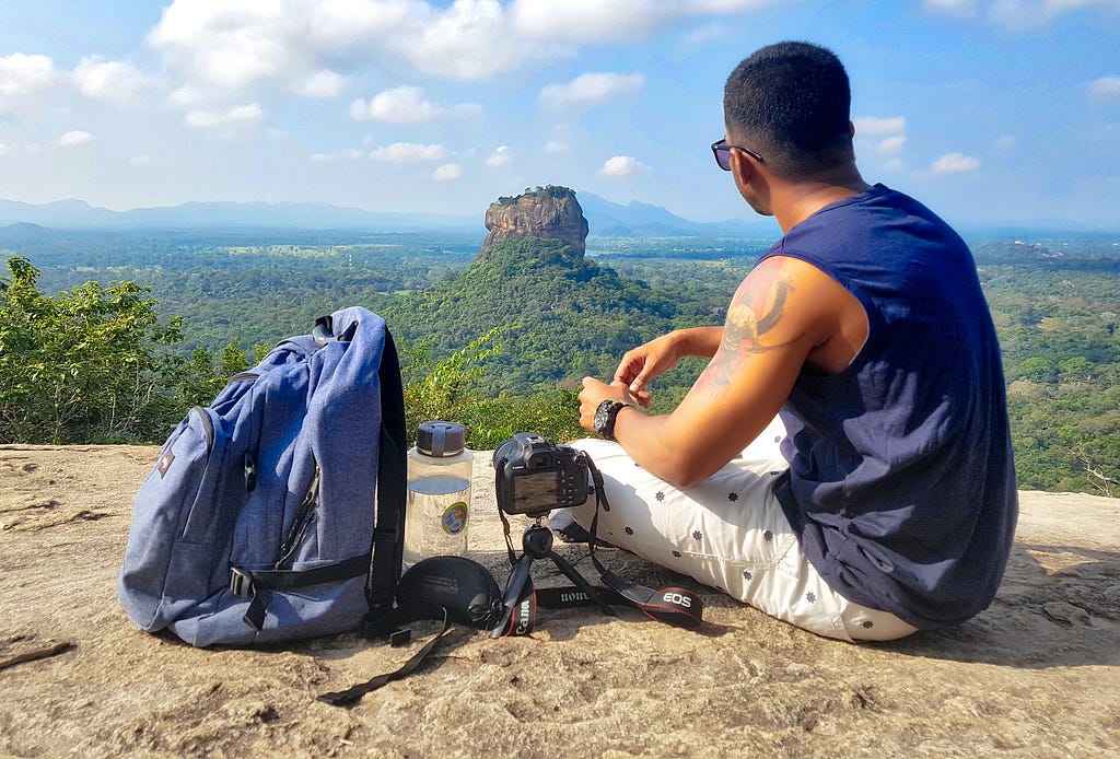 A traveler/hiker having a look at the broad horizon illustrating the notion of traveling helps us to broaden our perspectives.