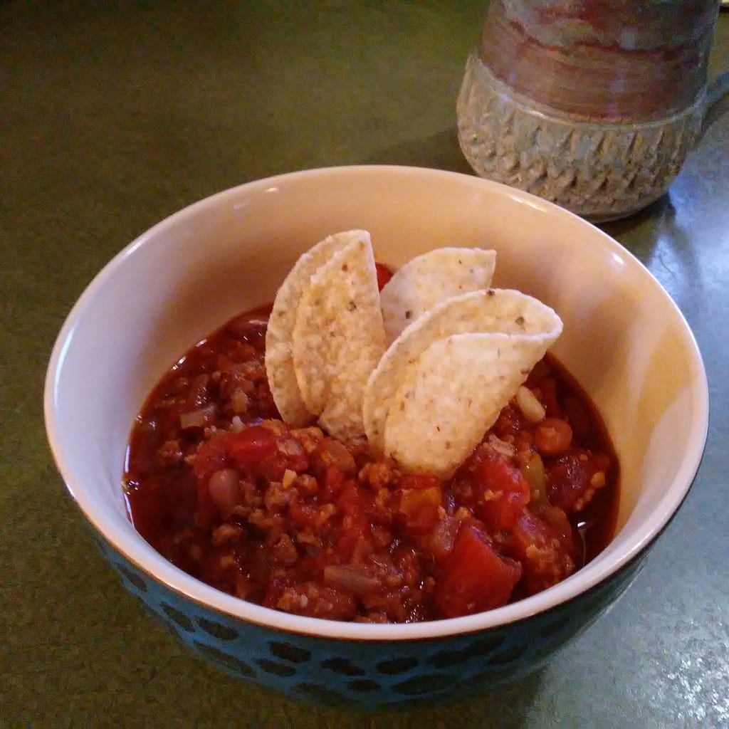 Beautiful Hot bowl of vegan chili with tortilla chips.