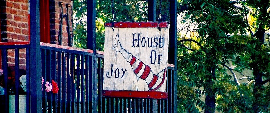 Store sign for House of Joy, a gift shop in Jerome AZ