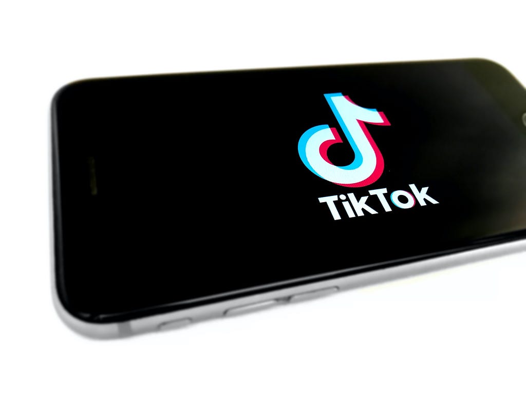An iPhone screen with the TikTok logo displayed