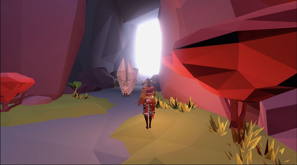 My character watches the white, two-tailed fox from a distance. Behind him is the entrance of the cave.