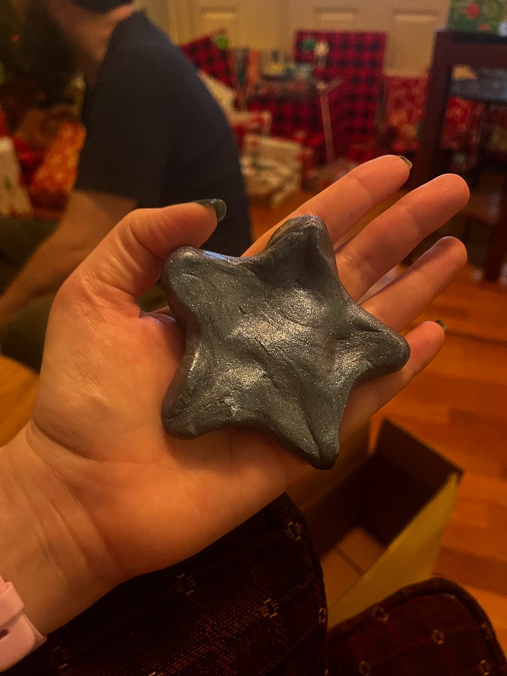 Photo of hand holding star shape formed with Aaron’s Thinking Putty