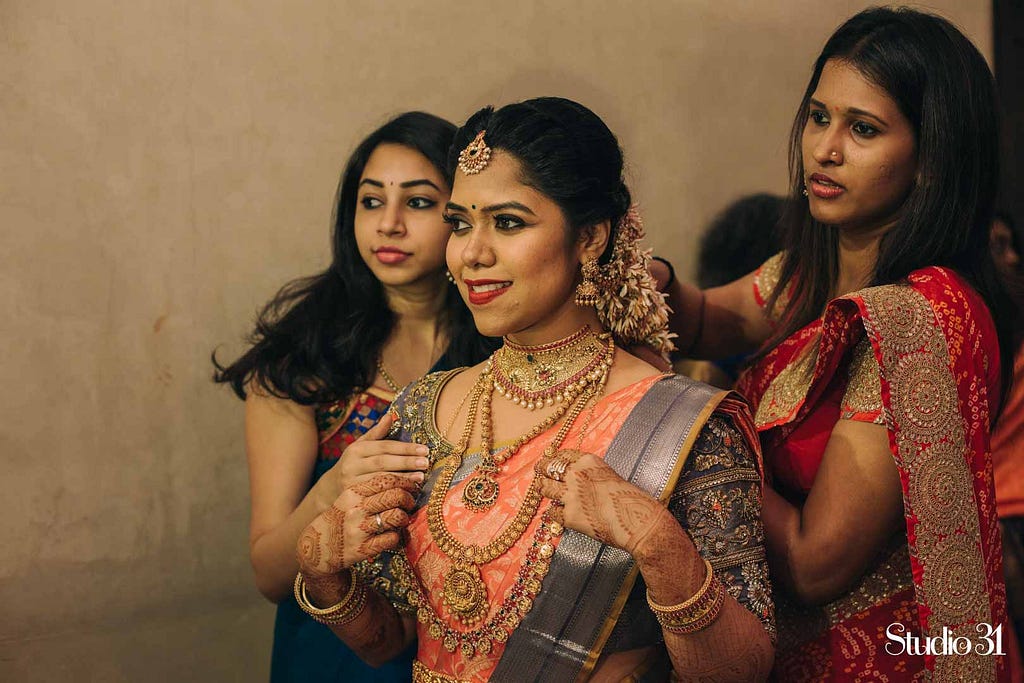 Getting ready shot of a bride by Studio 31 at Sree varaaham hall in Koyambedu, Chennai