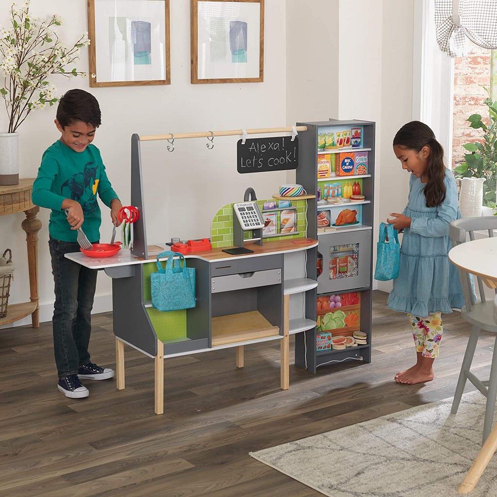 Two children playing together with KidKreft’s interactive 2-in-1 kitchen playset.