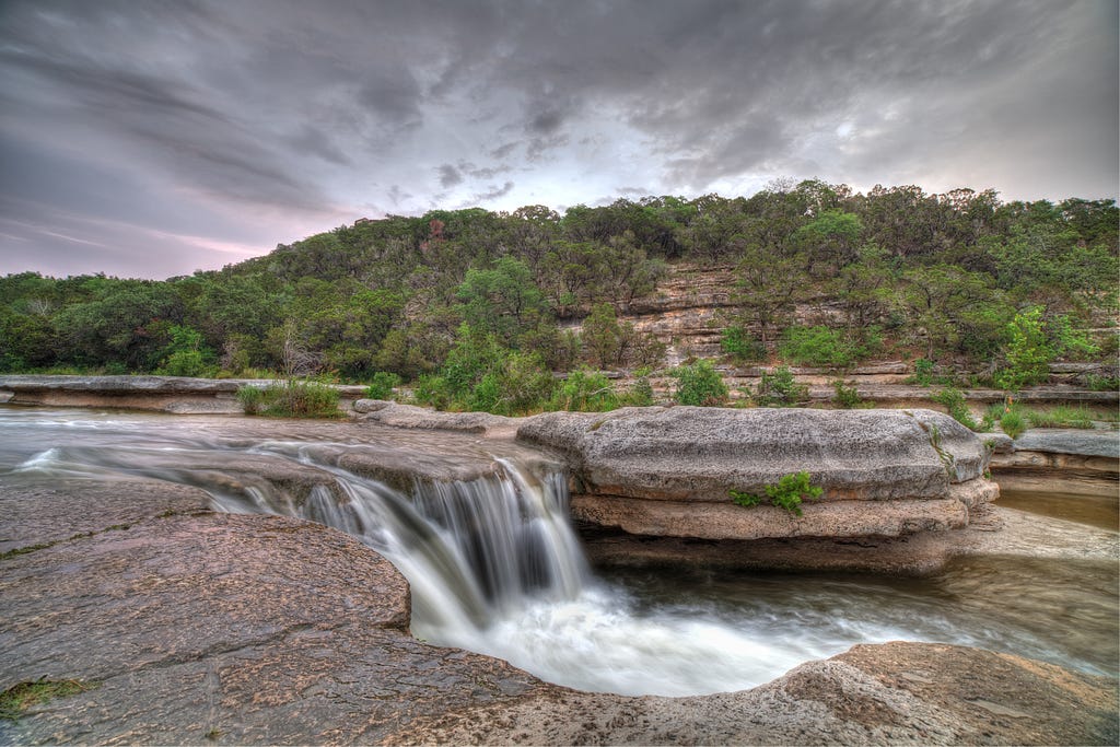 An image of a small waterfall in Bull Creek in Austin, Texas.
