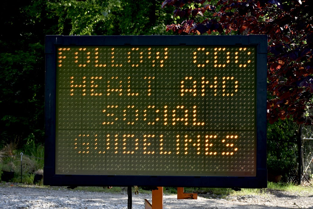 A digital traffic sign (with typo) alerts people to find and refer to CDC guidelines during the COVID-19 pandemic.
