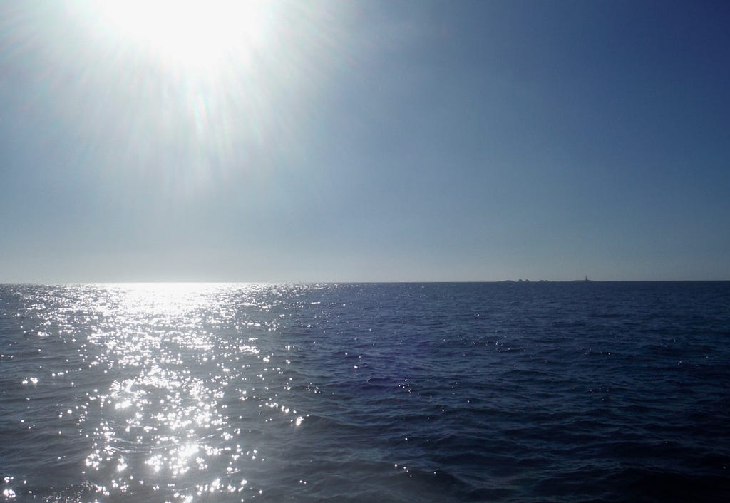 Photo of the sea surface with sun reflecting off the water