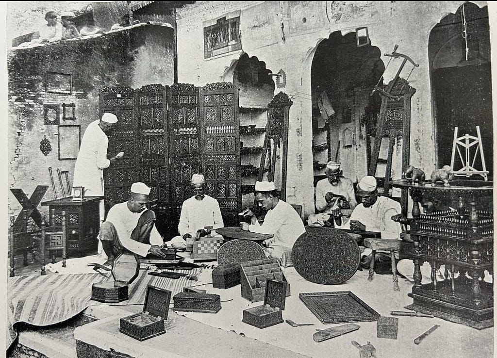 Black & White glimpse into the craftsmanship legacy: Artisans intricately carving wood at a Saharanpur Atelier.
