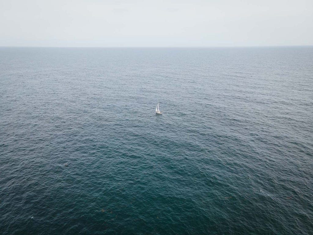 image of a boat in the middle of the ocean.