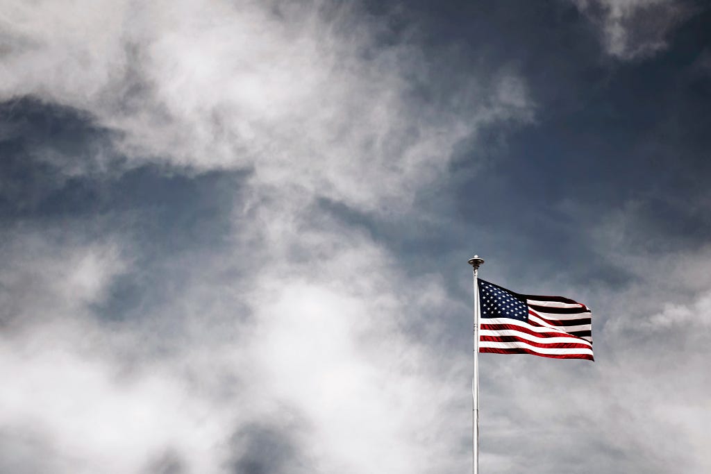 American Flag set against a stormy gray sky
