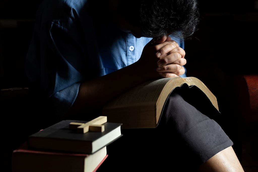 a photo of a woman praying reflecting the right way to interpret the bible