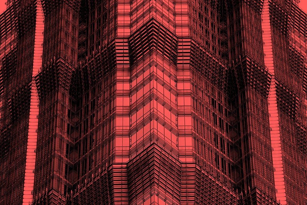 Close up of a geometric skyscraper’s corner overlaid with a red filter.