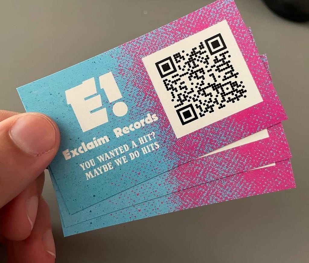 Exclaim Records business cards featuring the logo, a QR code, and the text, “YOU WANTED A HIT? MAYBE WE DO HITS”