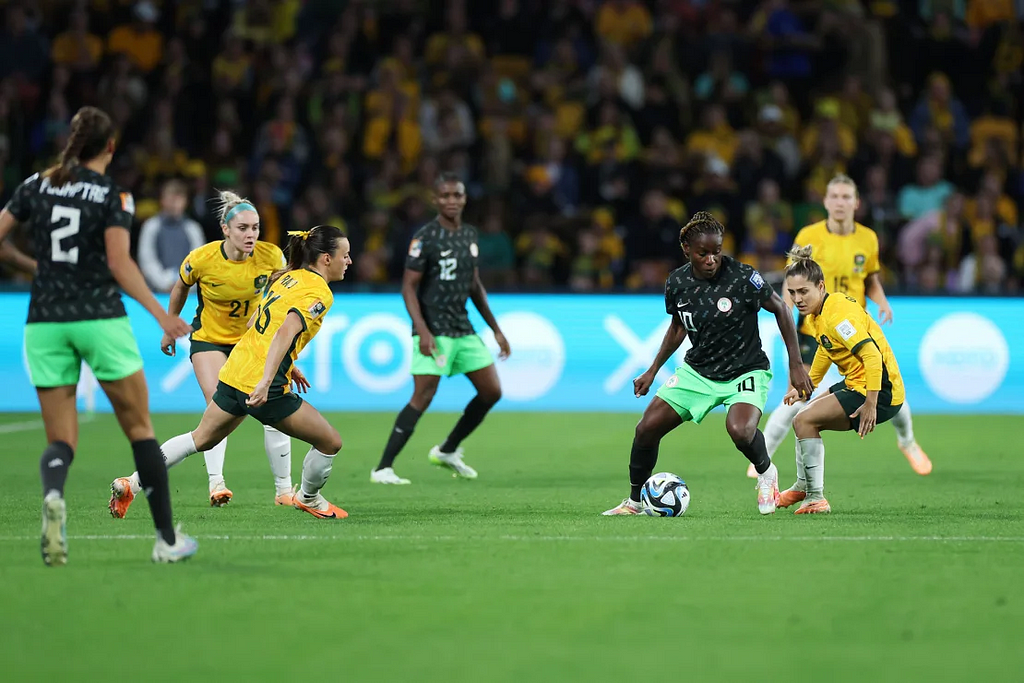 Nigerian Midfielder, Christy Ucheibe shield the ball while progressing play against Australia ©Shutterstock/Isabel Infantes