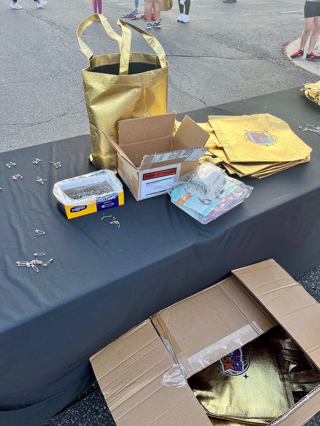 Race bibs, gold sparkly swag bags, and safety pins for the Fierce Fab 5K Run