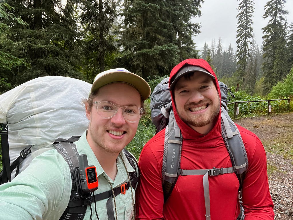 Jon and Logan with packs on and smiling