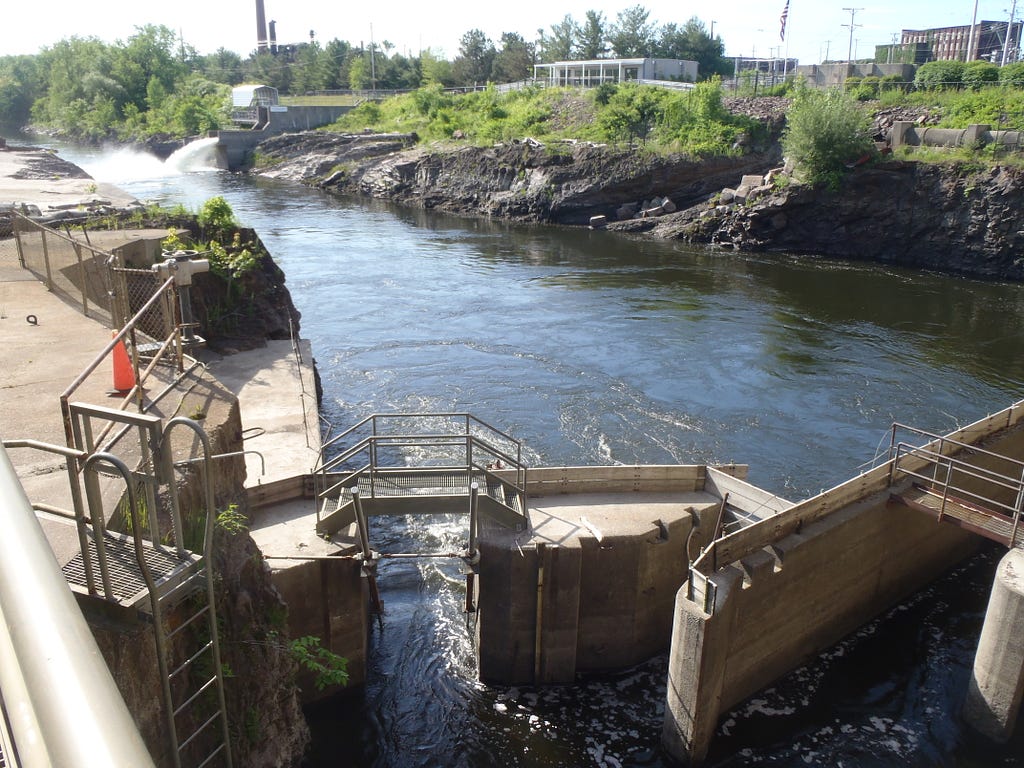 Water flows into a dam on a river