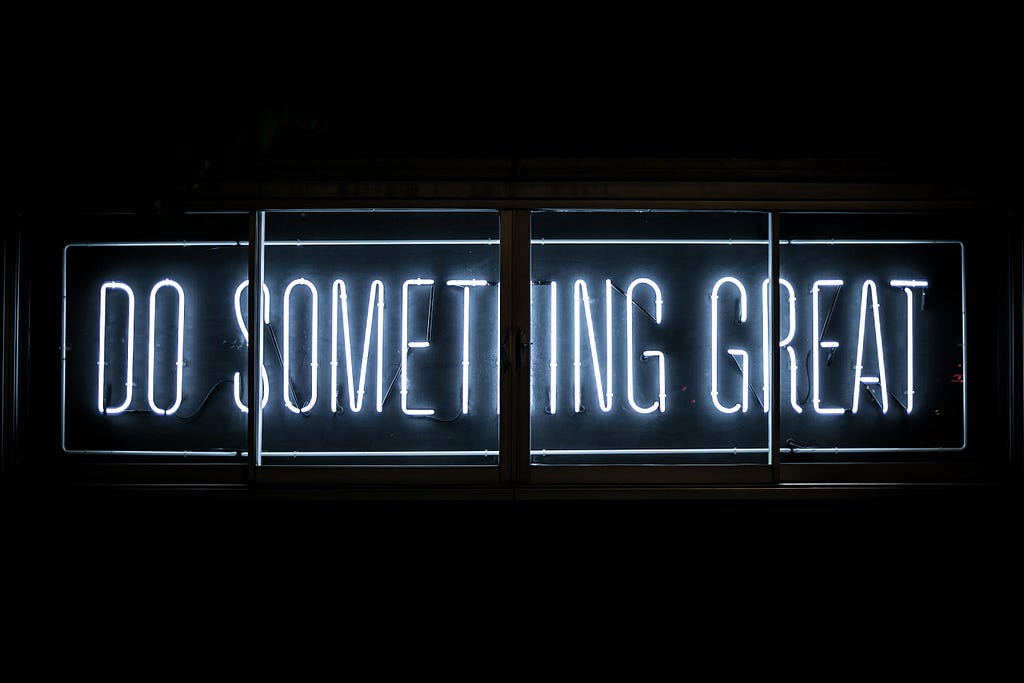 Neon sign that reads “Do Something Great.” Photo by Clark Tibbs on Unsplash.