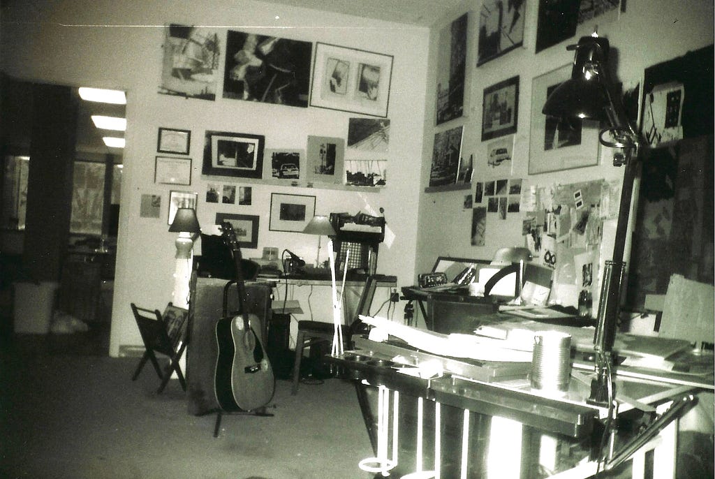black and white photo of a cluttered art studio