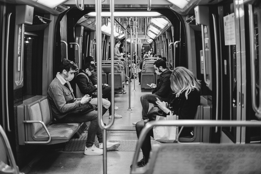 People sitting in a train looking at their smartphones