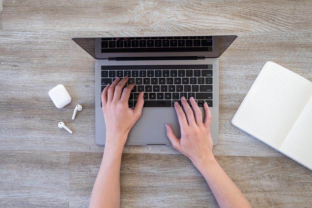 Hands typing on a laptop keyboard representing starting an online business