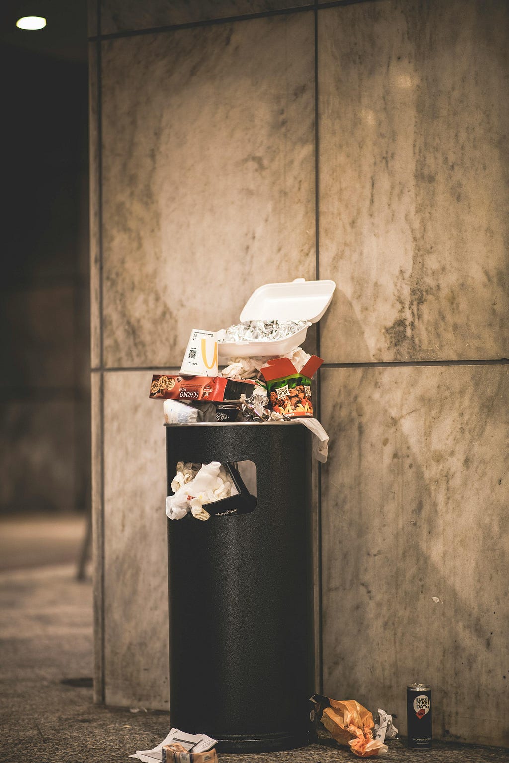 Tory manifesto represented by a bin full of overflowing rubbish