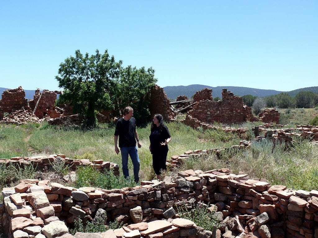 Erik Wøllo and Deborah Martin at the Kinishba site in Arizona, bricks remain from long ago. This story is about music created after visiting this place.