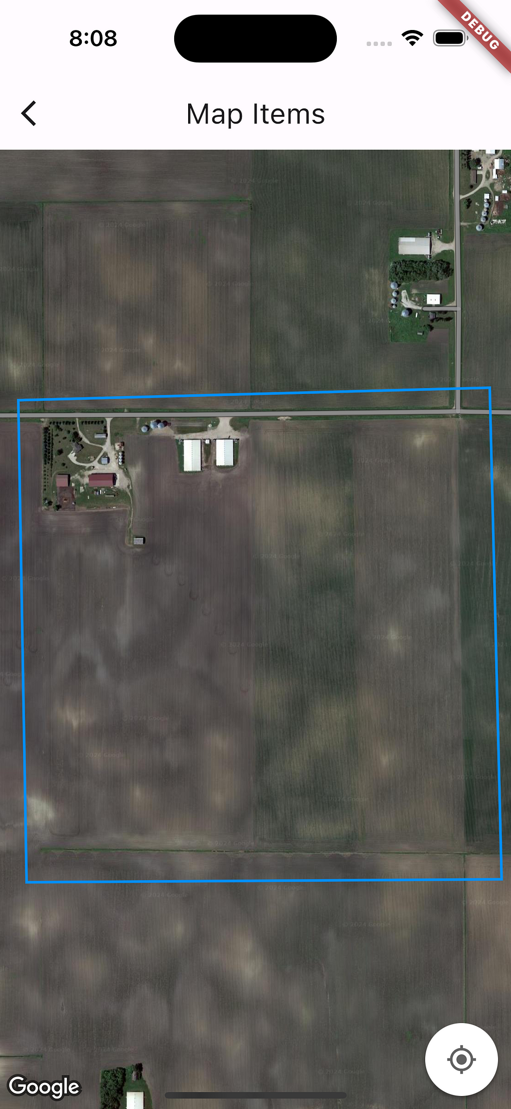 A screenshot of a map open on a smartphone. The map is showing satellite image of a farm in Northern part of USA. A line is drawn on the map. The colour of the line is sky blue.
