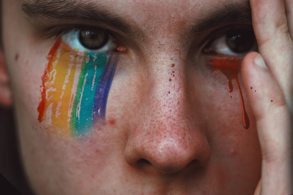 nonbinary with rainbow tears on right and blood tears or left
