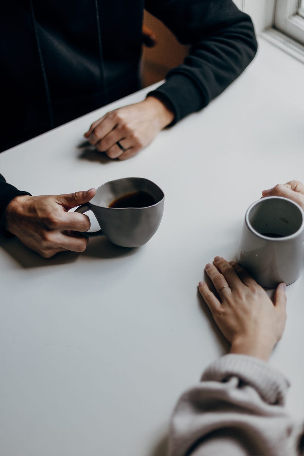 Two people drink some coffee.