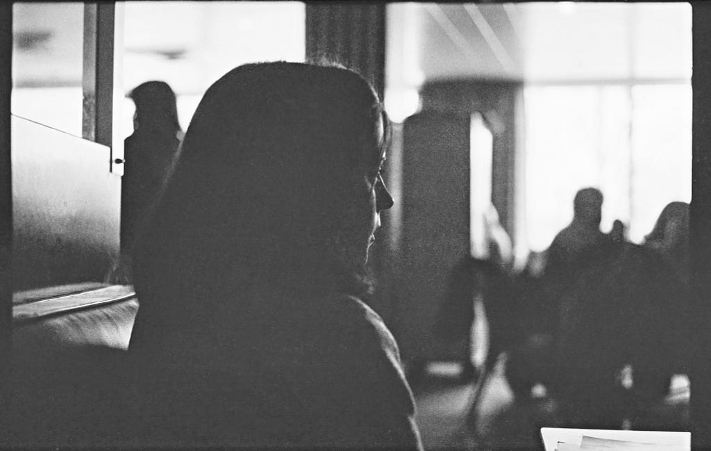 Underexposed black-and-white 35mm photograph of Patty Haffner taken in 1979 at the Bowling Green State University Student Union, Bowling Green, Ohio.