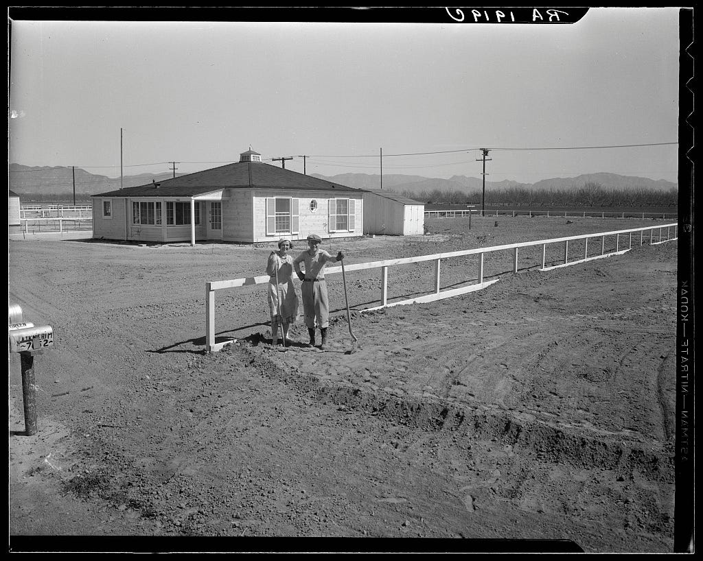 Photo of couple in front of one San Fernando federal subsistence homesteads (25 miles northwest of Los Angeles City Hall). Forty homes, all occupied, each with nearly an acre of ground. California. (Note: average income of homesteaders was $800/yr, or $17,721 in 2023 dollars) Credit: Dorothea Lange, Feb 1936, Library of Congress Prints and Photographs Division.