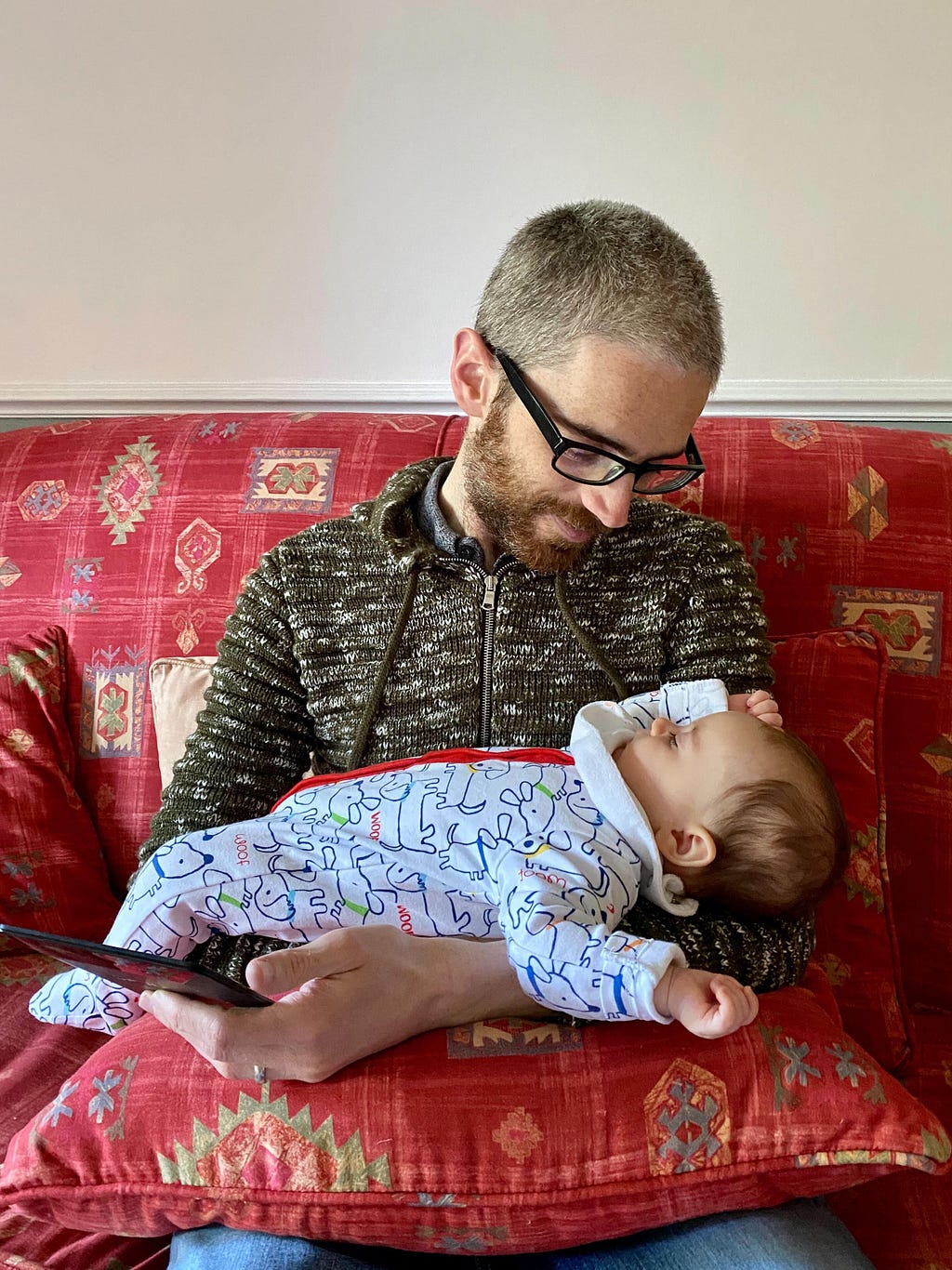 A picture of my daughter, Clodagh, asleep on top of me as I read a book on my Kindle.