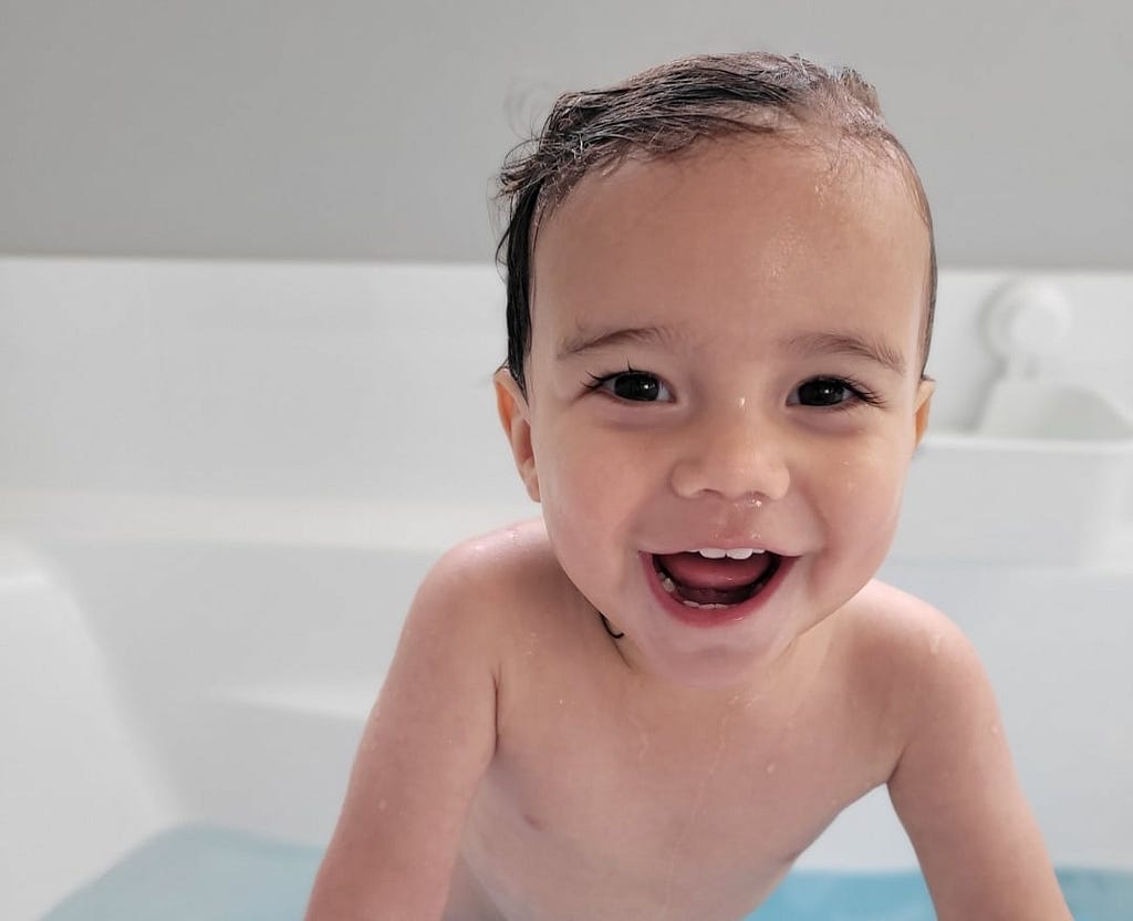 Milo smiling in the bath