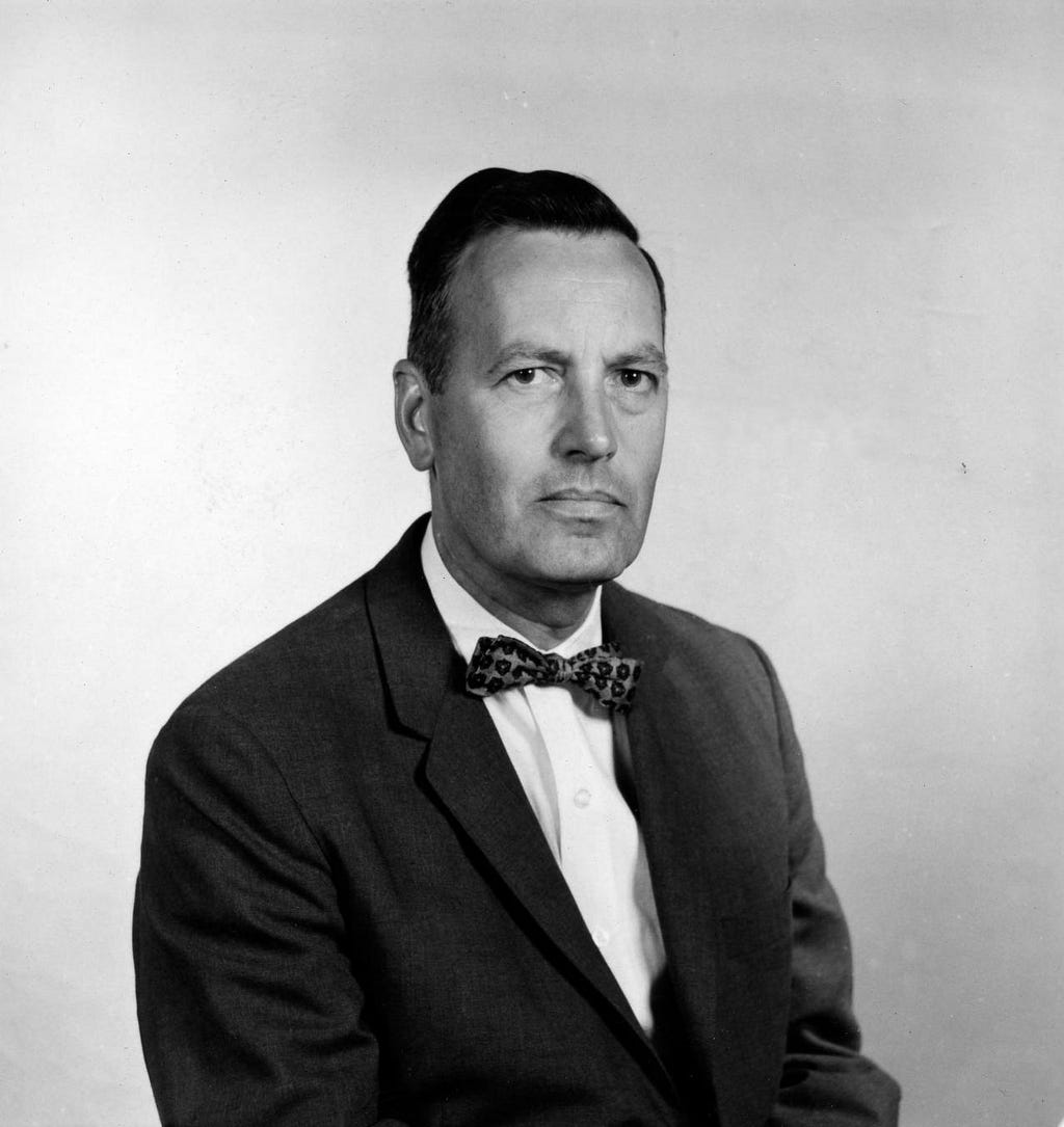 Black-and-white portrait of a man in a suit and bow tie.