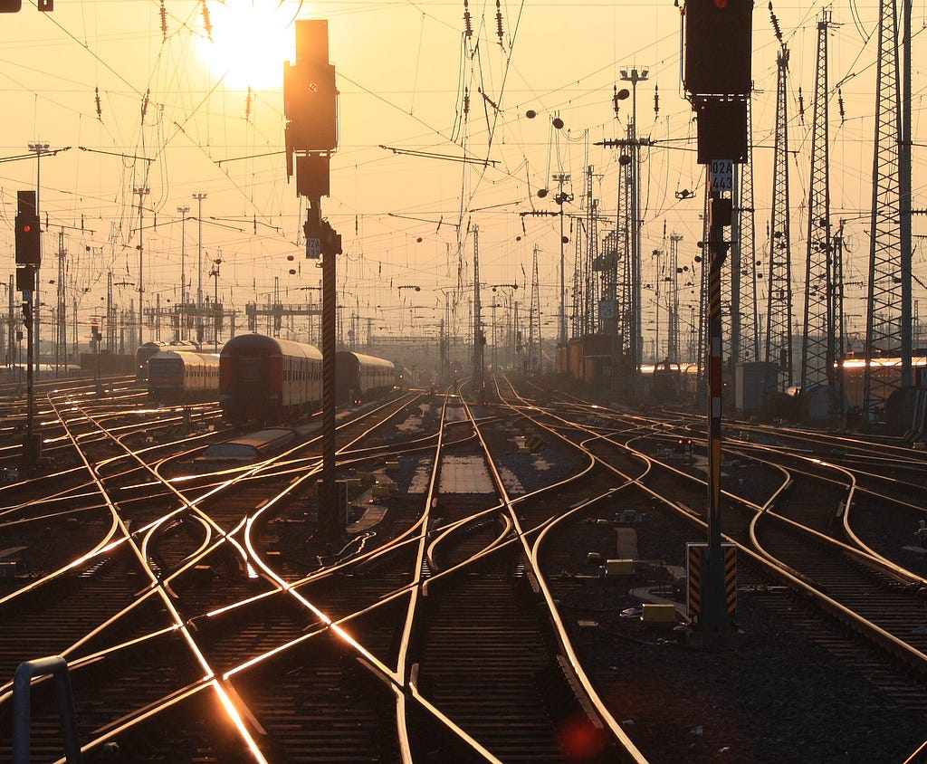 Railway tracks in the sunset. Taken at Frankfurt Central Station. Image on Wiki by Arne Hückelheim.