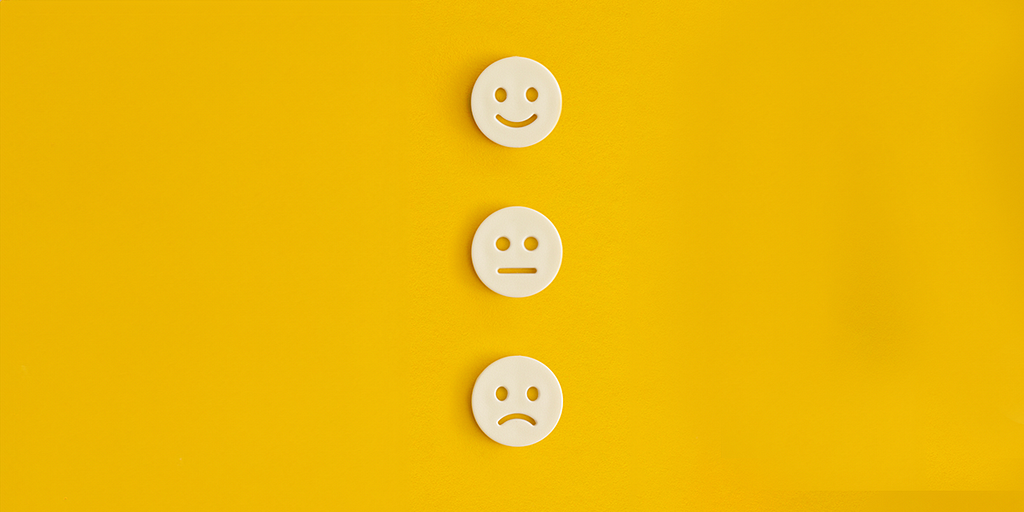 A series of smiley faces ranging from sadness, neutrality, and happiness
