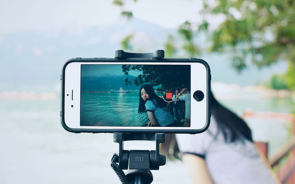 photo from behind a phone livestreaming a trip to the beach
