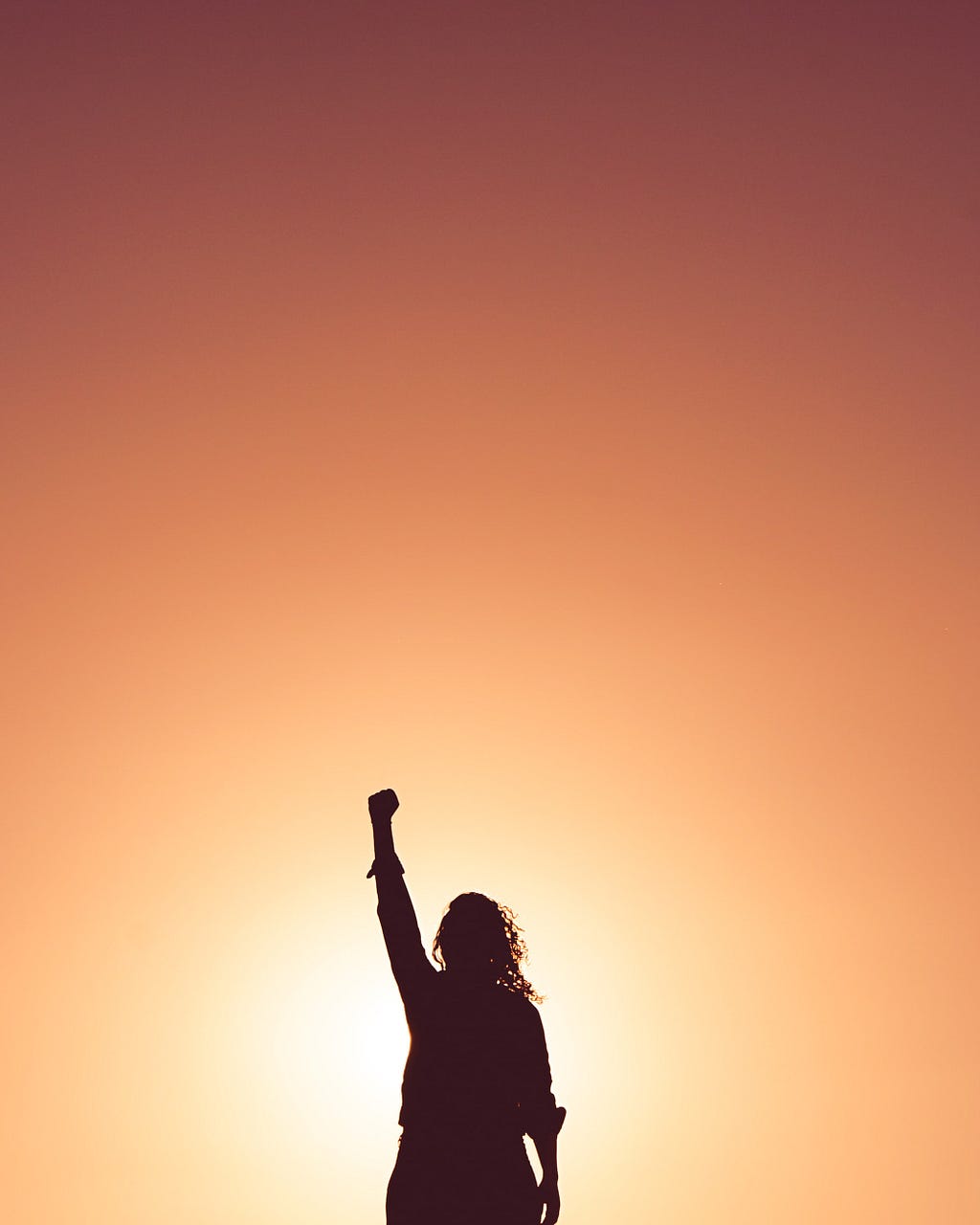 picture of a woman with fist in the air