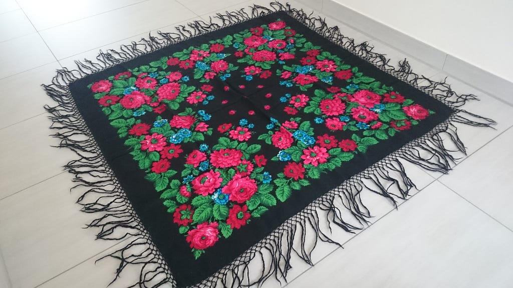 Black shawl with flower pattern on the floor