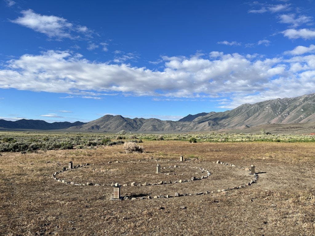 A spiral line of  field rocks and test rammed earth sections delineate the boundary of “The Source,” one of the top ten LAGI 2020 Fly Ranch projects, showing the space it will occupy once it is built.