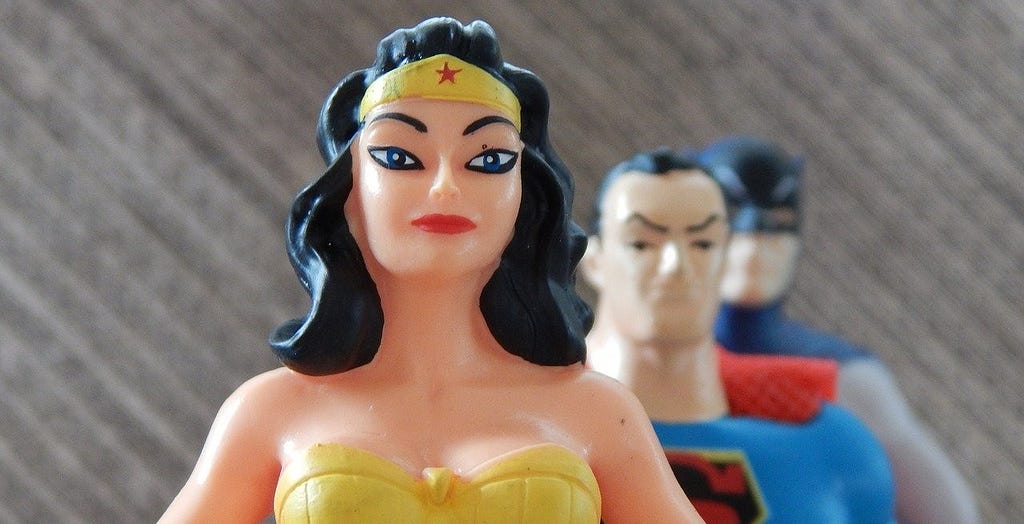 Image showing close up of rubber action figures, namely Wonder Woman, Superman, and Batman.
